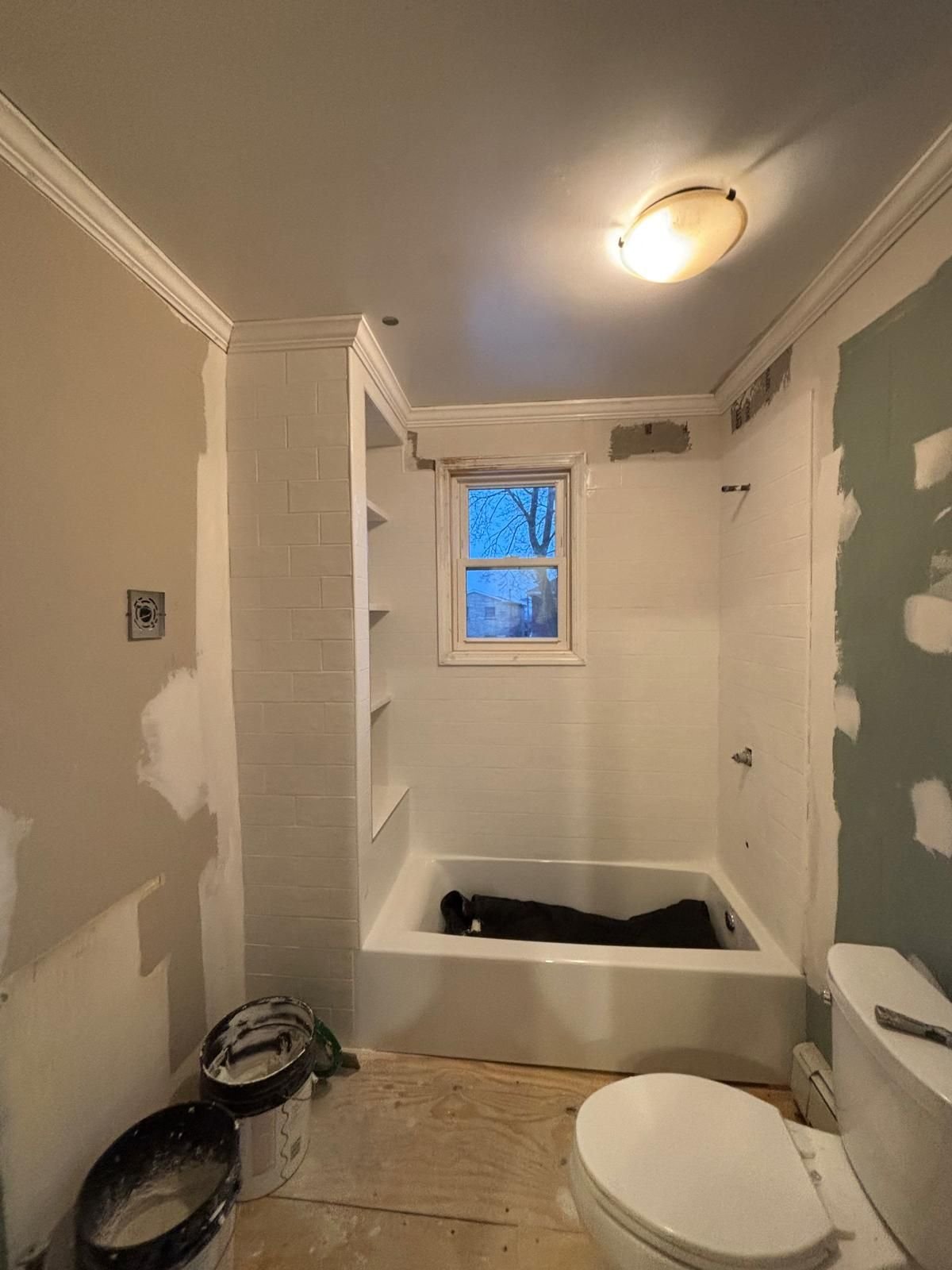 Before: bathroom walls patched and skim coated, ready for paint