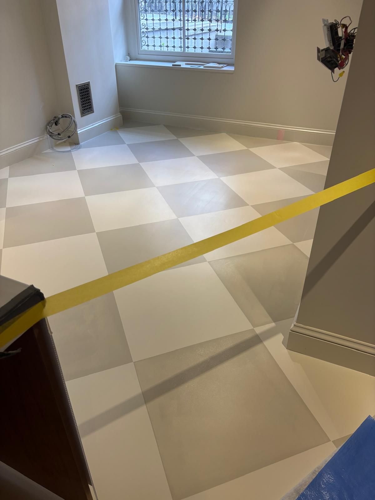Checkerboard floor finish in progress