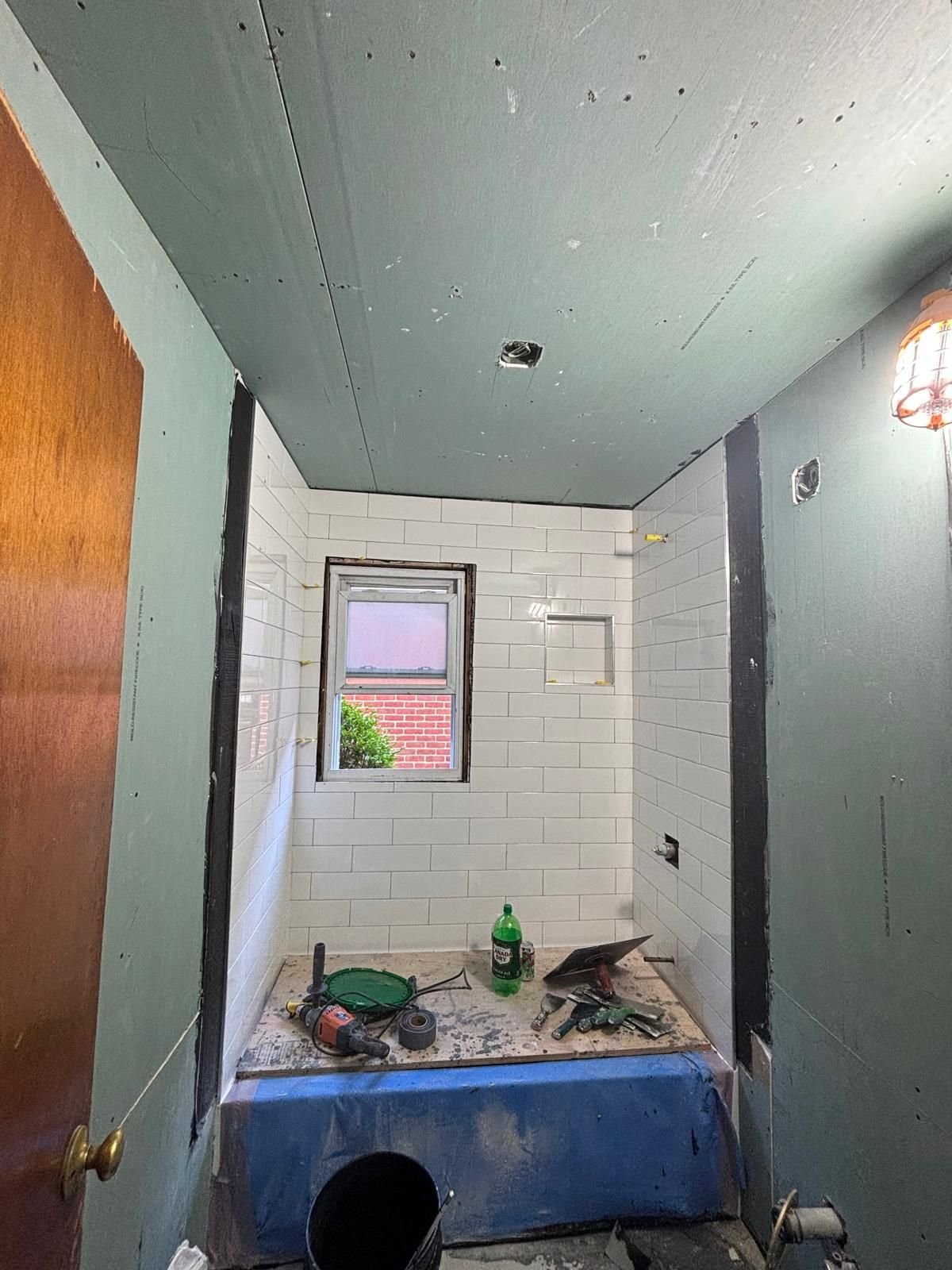 New moisture-resistant drywall going up in a bathroom