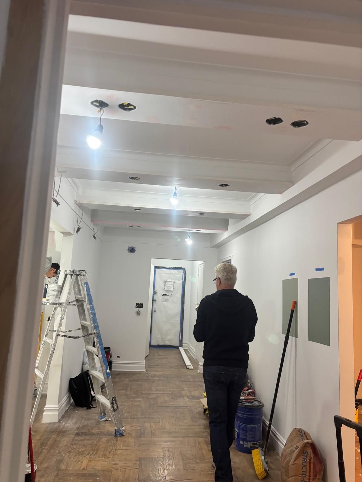 Hallway and ceiling beams in white, mid-project