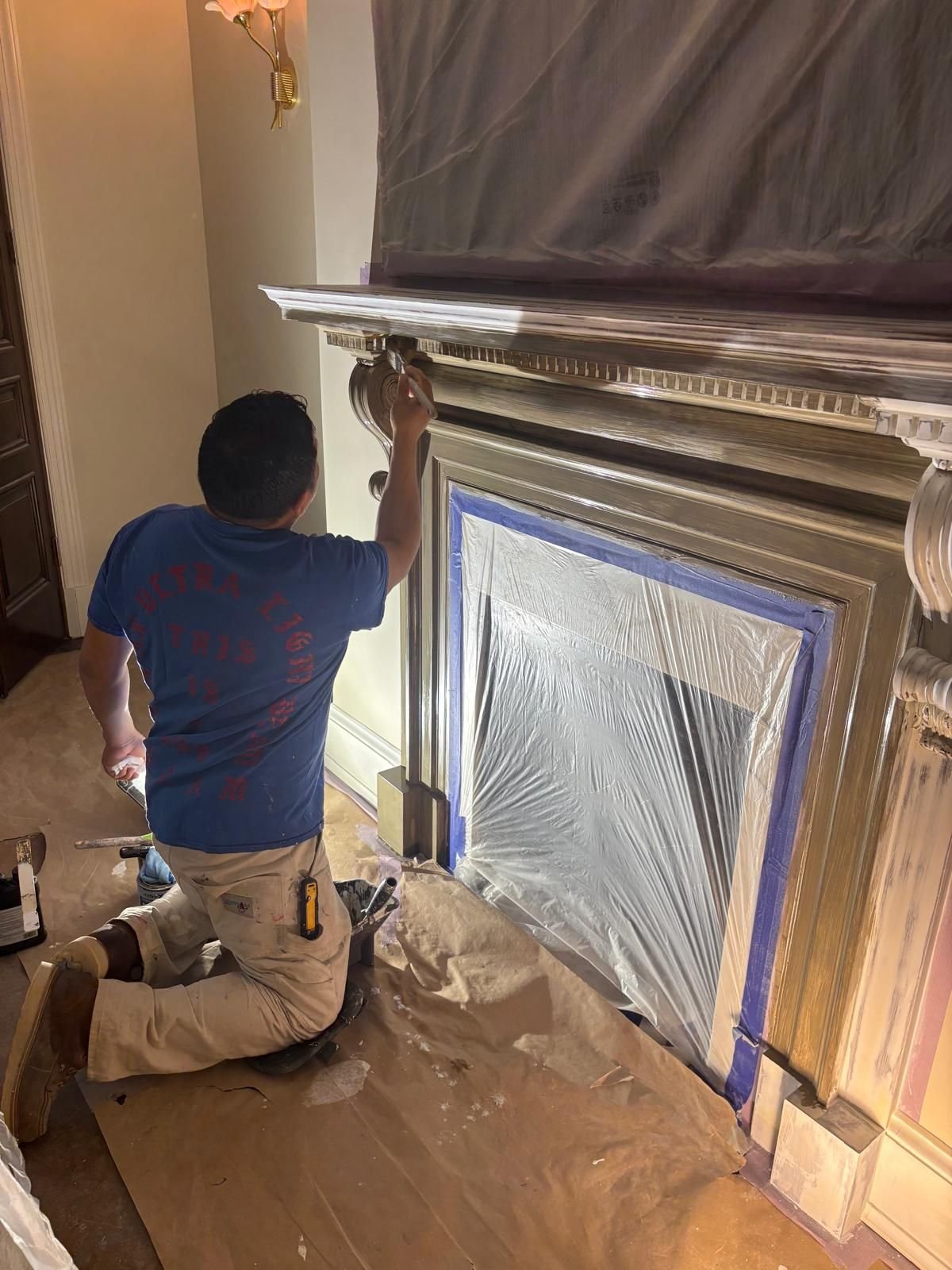 Hand-finishing the details of a fireplace mantel
