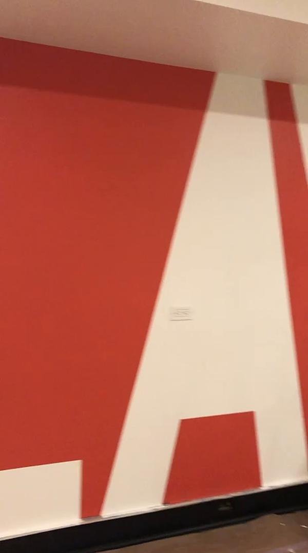 Large red wall graphic in a commercial space