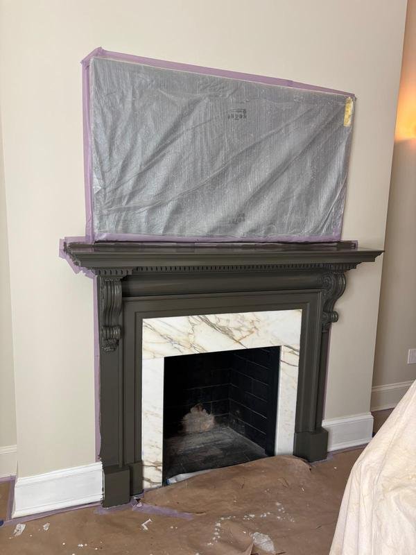 Fireplace mantel refinished in deep charcoal