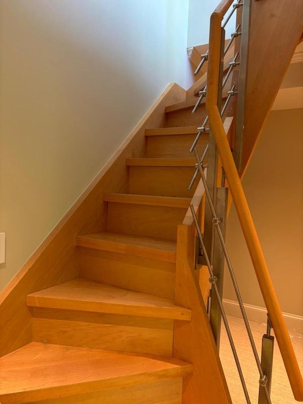 Fresh wall paint along a wood staircase